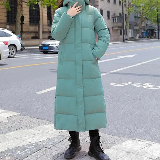 Women's long quilted hooded parka in insulated lightweight design with horizontal stitched panel structure