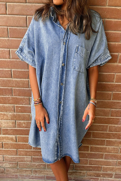 Women's oversized denim shirt dress in blue with short sleeves and classic button-front closure