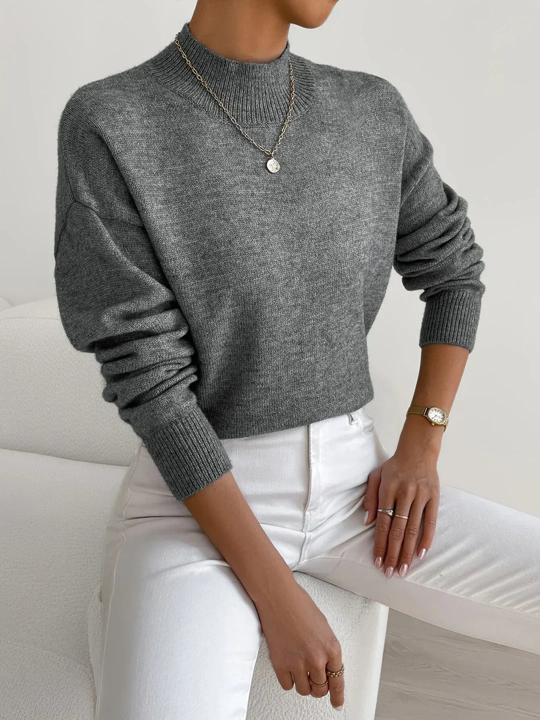 Elegant cream turtleneck sweater with slim flattering fit and classic neckline design