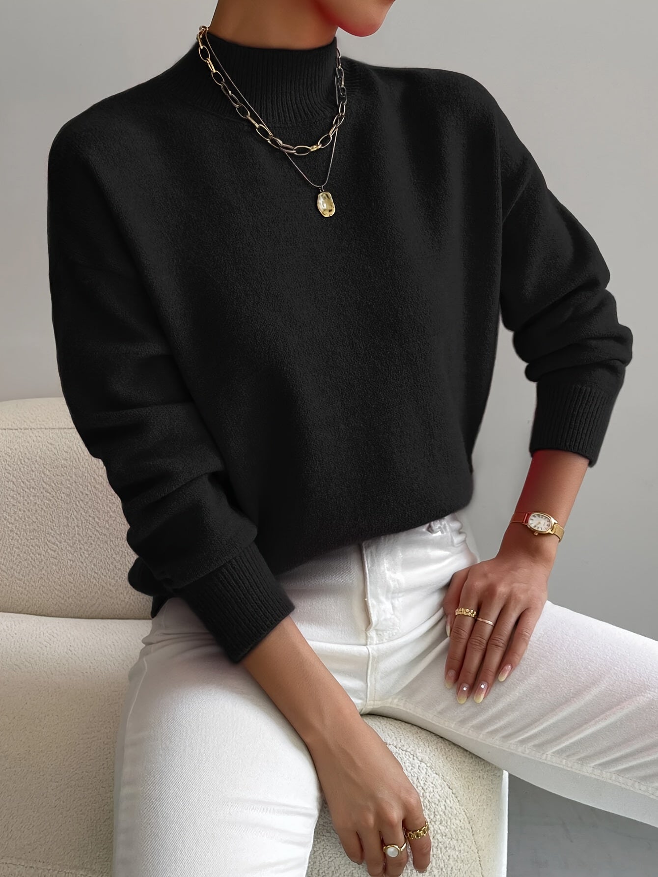 Elegant cream turtleneck sweater with flattering fitted cut and elongating neckline design