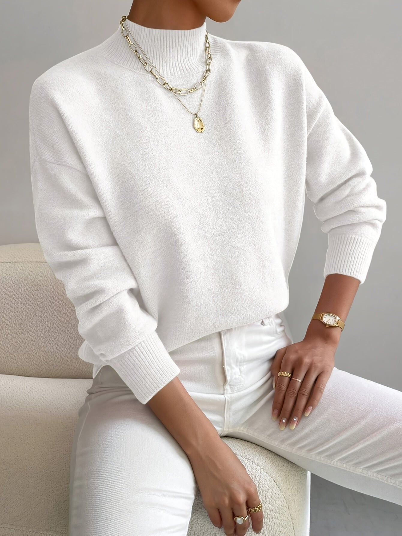 Elegant cream turtleneck sweater with flattering slim fit and classic ribbed neckline design