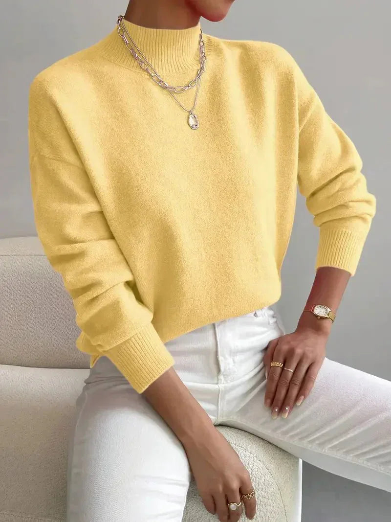 Elegant cream turtleneck sweater with flattering slim fit and classic ribbed neckline detail