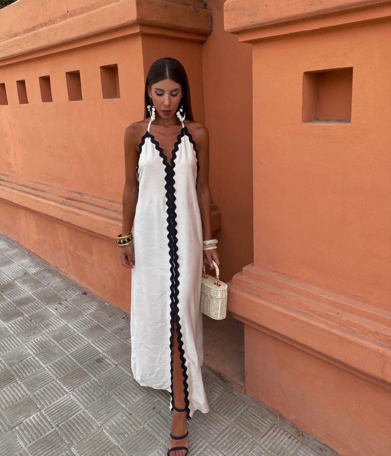 Women's elegant wrap dress in fluid fabric with figure-lengthening silhouette, perfect for wedding guests
