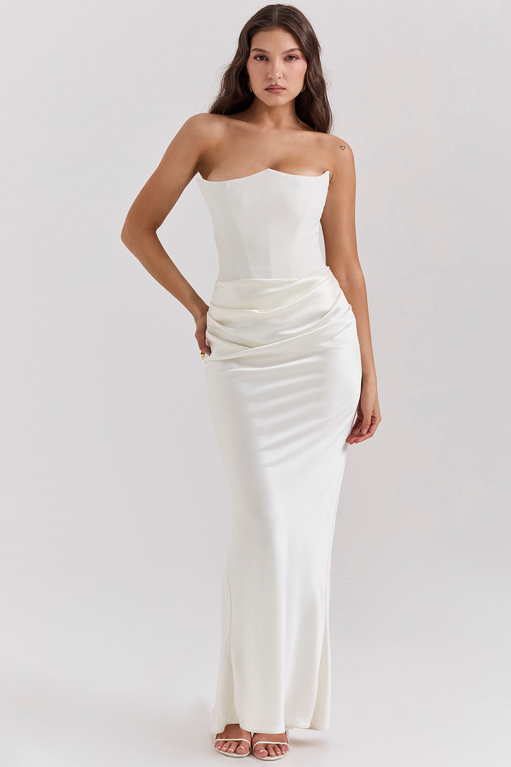 Strapless floor-length black gown with structured bodice and graceful draping for women
