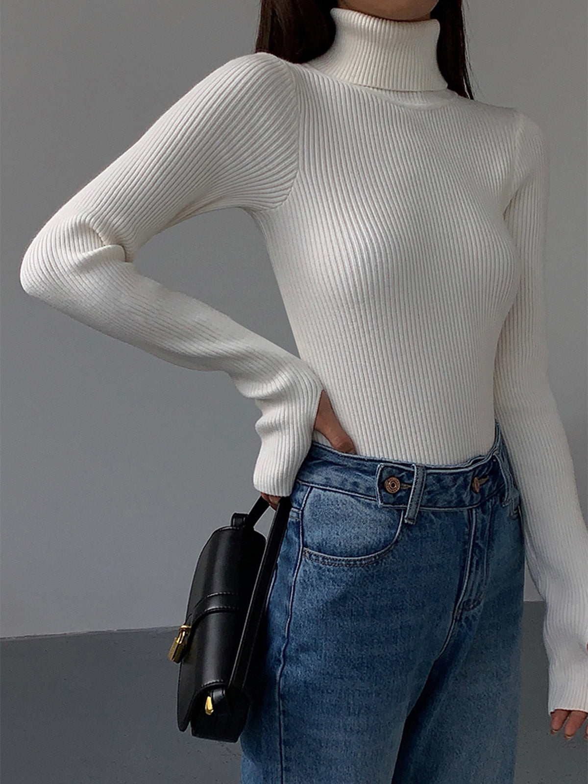 Minimalist slim fit turtleneck knit top in neutral tone with elegant casual style and medium stretch