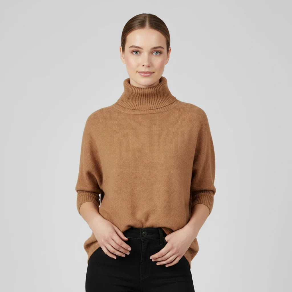 Women's oversized turtleneck knit sweater with drop shoulders and short sleeves for cozy layering