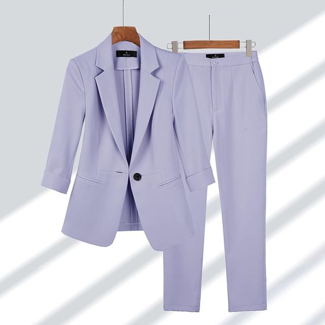 Women's slim-fit tailored blazer and trousers suit set, single-button closure, sleek formal style