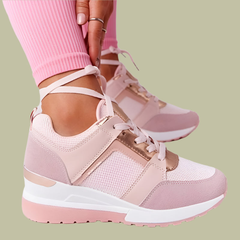 Women's white wedge sneakers with breathable perforations, lace closure, and hidden height-boosting rubber sole