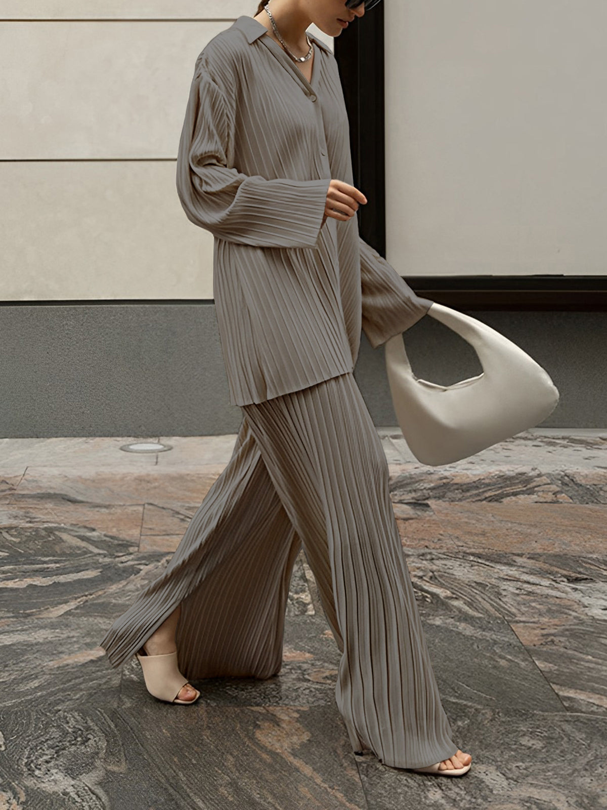 Oversized pleated two-piece pants set in neutral tones with pleat detail pockets, casual leisure style