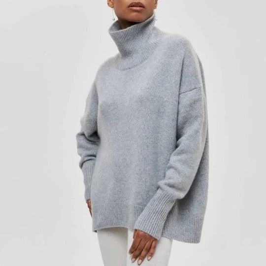 Cream oversized turtleneck sweater with relaxed silhouette and soft textured knit fabric
