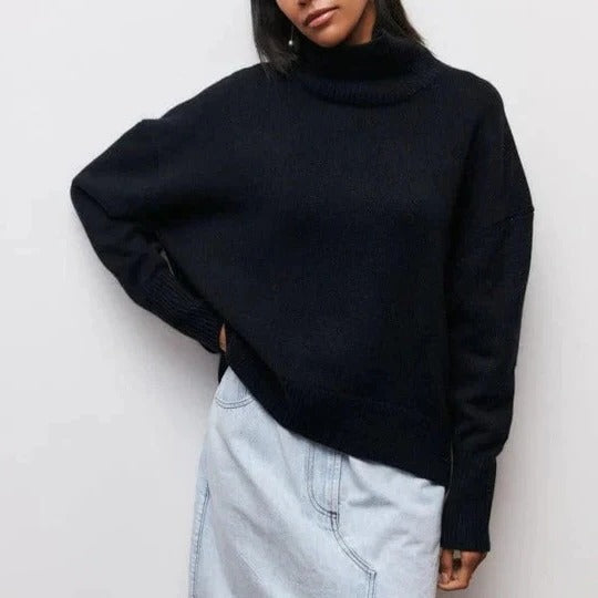 Cream oversized turtleneck sweater with relaxed fit, soft textured knit, and high collar