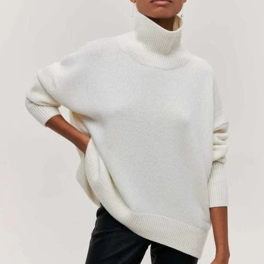 Cream oversized turtleneck sweater with relaxed fit, textured knit fabric, and high collar