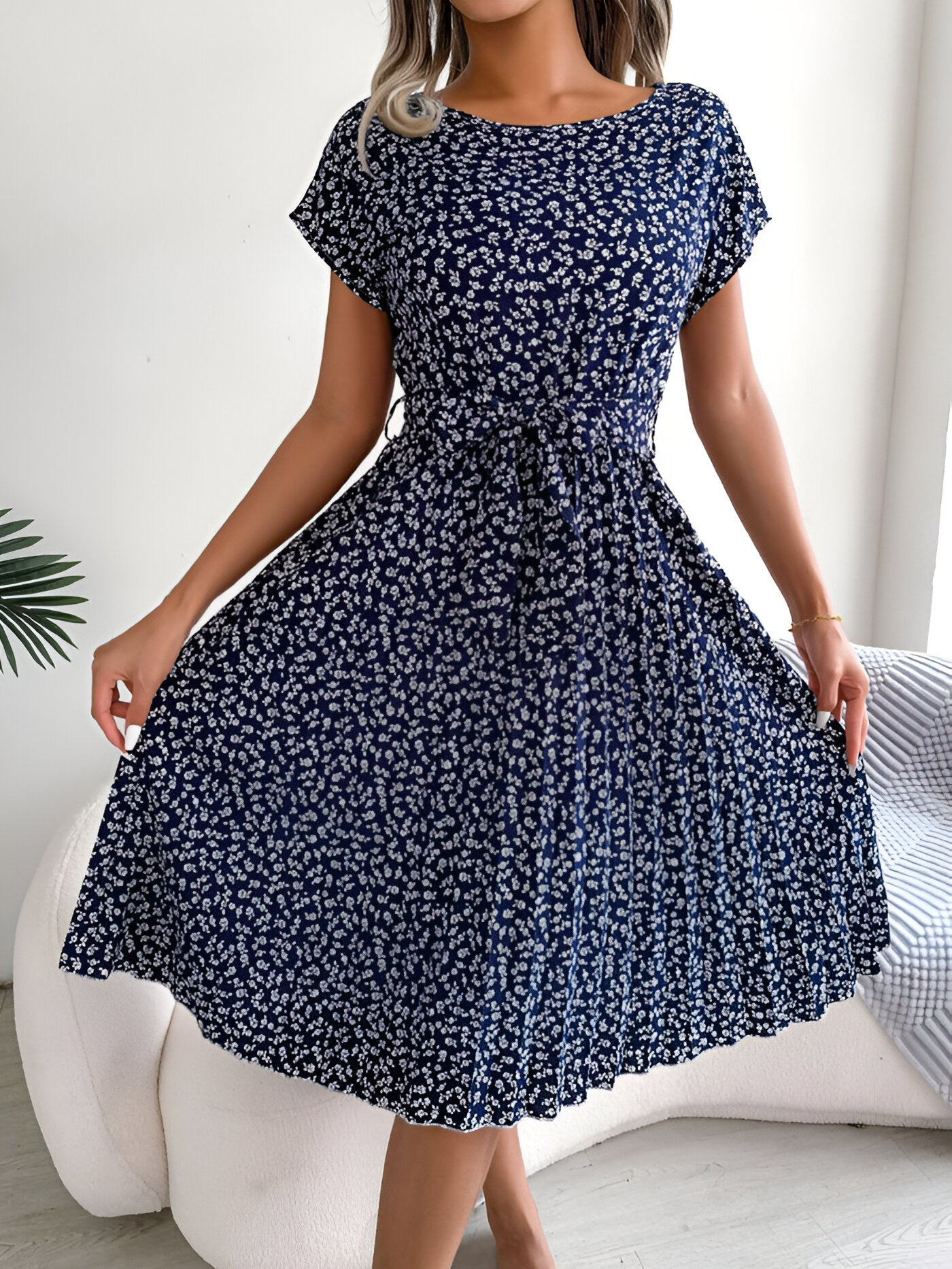 Floral pleated A-line dress in vibrant multicolor print with flowing soft skirt and elegant feminine silhouette