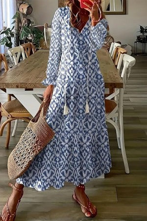 Women's boho floral print maxi dress with V-neck tassel detail, flowing A-line silhouette