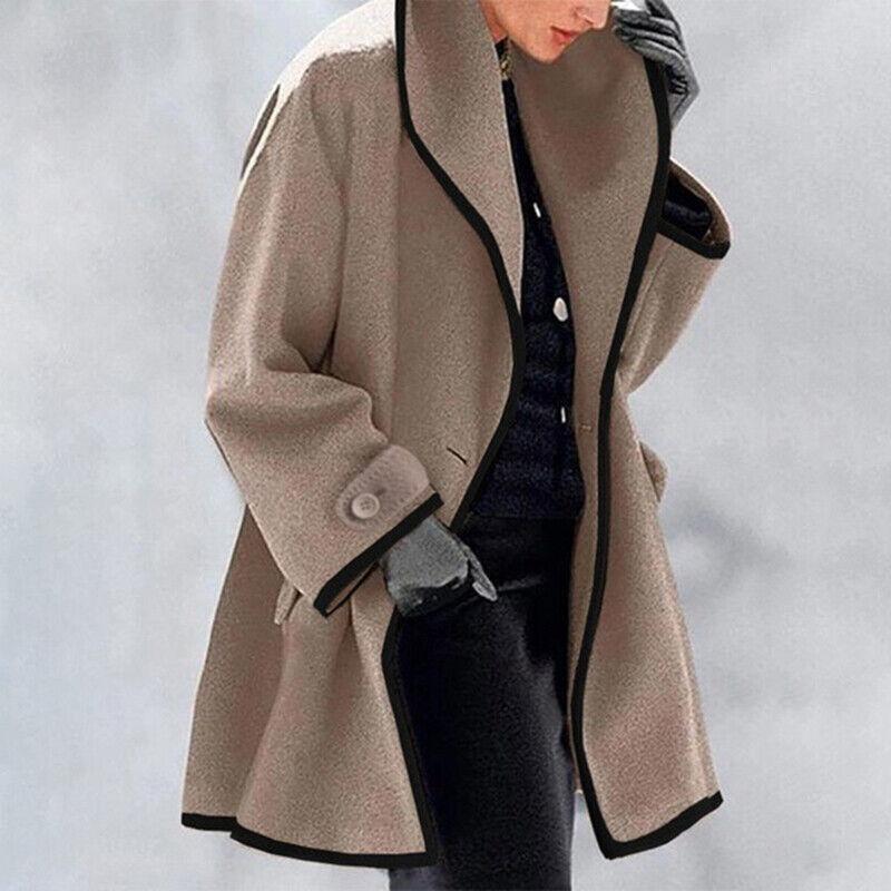 Ivory oversized coat with wide lapel collar, contrast trim, and relaxed silhouette for winter elegance