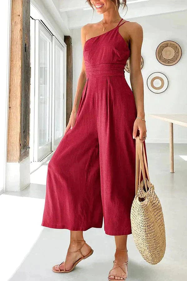 Women's black one-shoulder cotton jumpsuit with fitted waist and cropped wide-leg silhouette