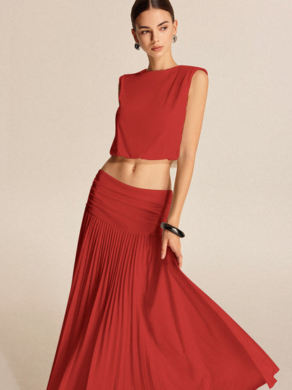 Shoulder-padded pleated skirt set in jersey fabric with invisible zipper and structured fit