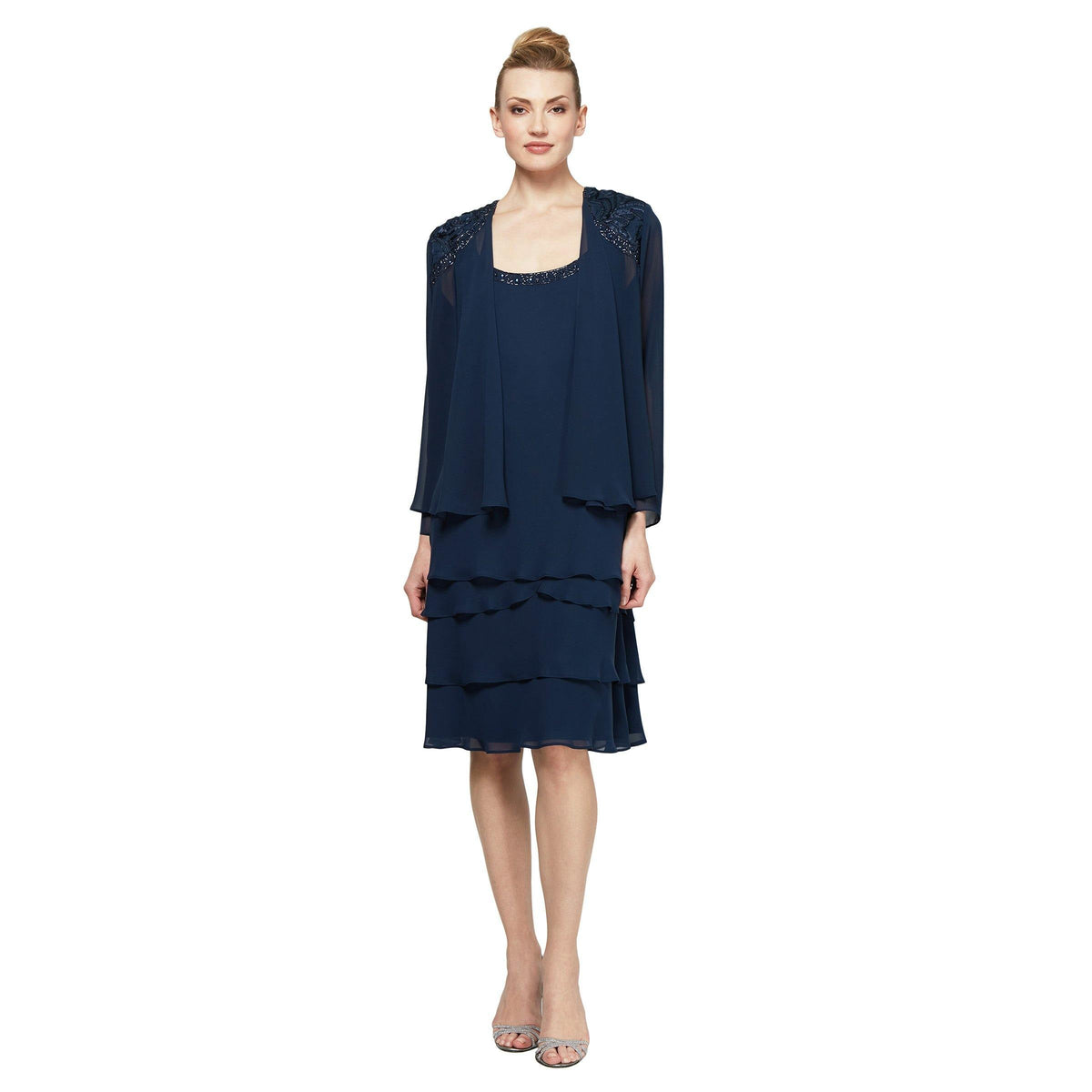 Knee-length chiffon tiered dress with beaded scoop neckline and matching long sleeve jacket in soft neutral tones