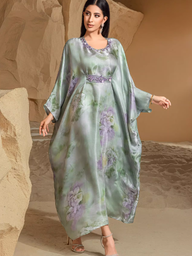 Silk holiday dress with green fruit print, batwing sleeves, elegant draped silhouette