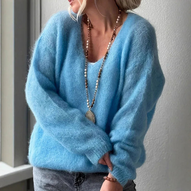 Oversized fluffy v-neck knit sweater in cozy autumn tones with soft loose-fit silhouette