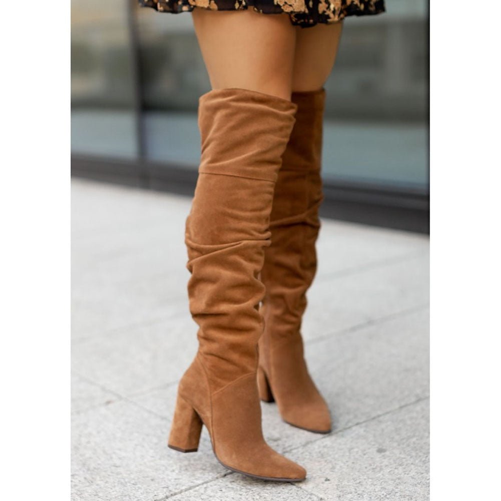 Black thigh-high slouchy block heel boots with pointed toe and over-the-knee shaft