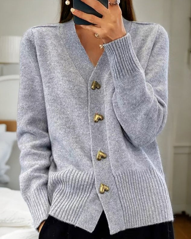 Elegant cream knit cardigan with heart-shaped buttons, flattering silhouette, and soft breathable fabric