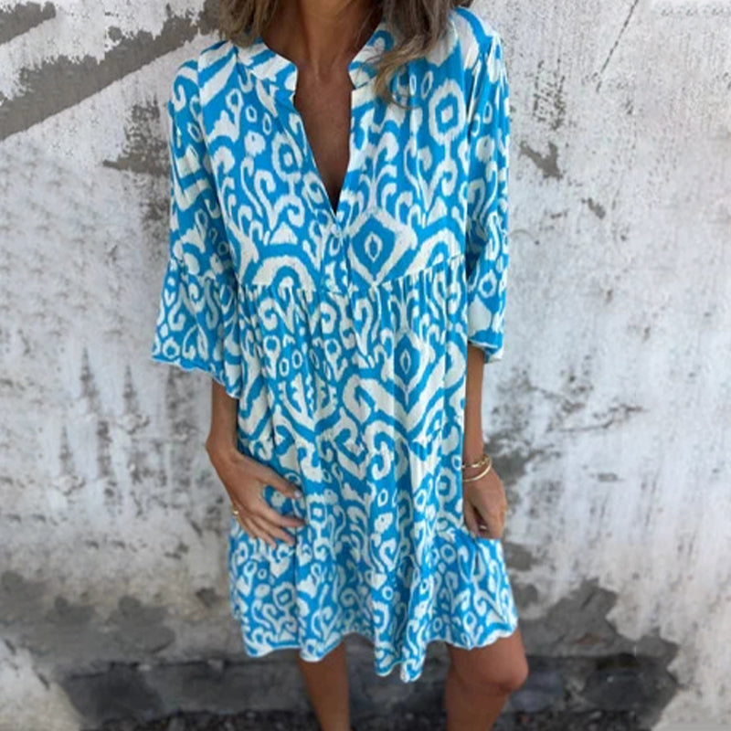 Women's elegant draped dress with chic printed sleeves, flattering silhouette in soft sophisticated style
