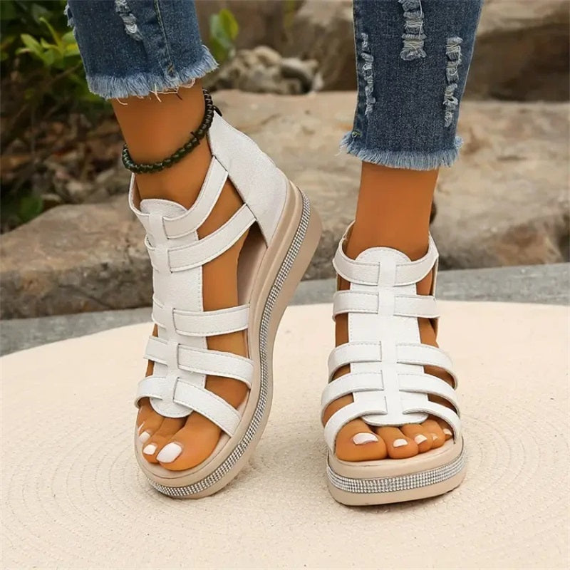 Black strappy platform sandals with multi-strap upper and back zip closure for elevated bold style