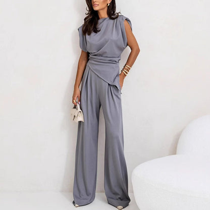 Elegant two-piece set in neutral tones, structured silhouette with draped fabric detail