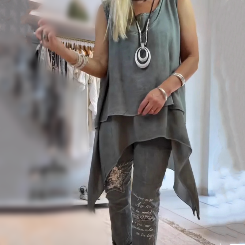 Women's two-piece set sleeveless asymmetric top with vibrant floral wide-leg pants coordinated outfit