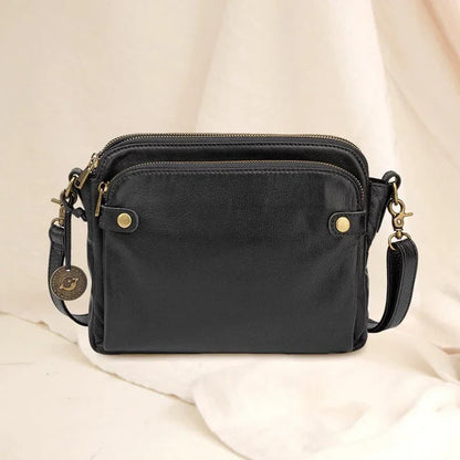 Black leather structured shoulder bag and clutch with three-section interior, sleek modern silhouette
