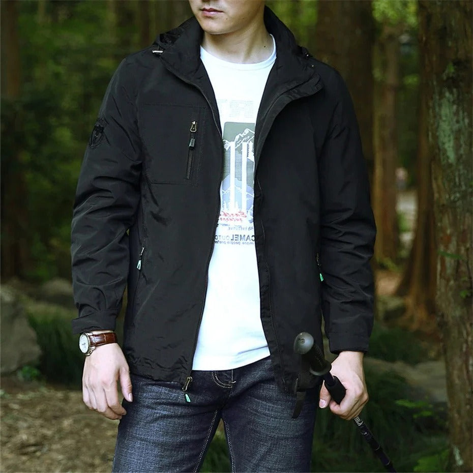 Lightweight waterproof adventure jacket in neutral tones, windproof hooded cut for rainy outdoor days