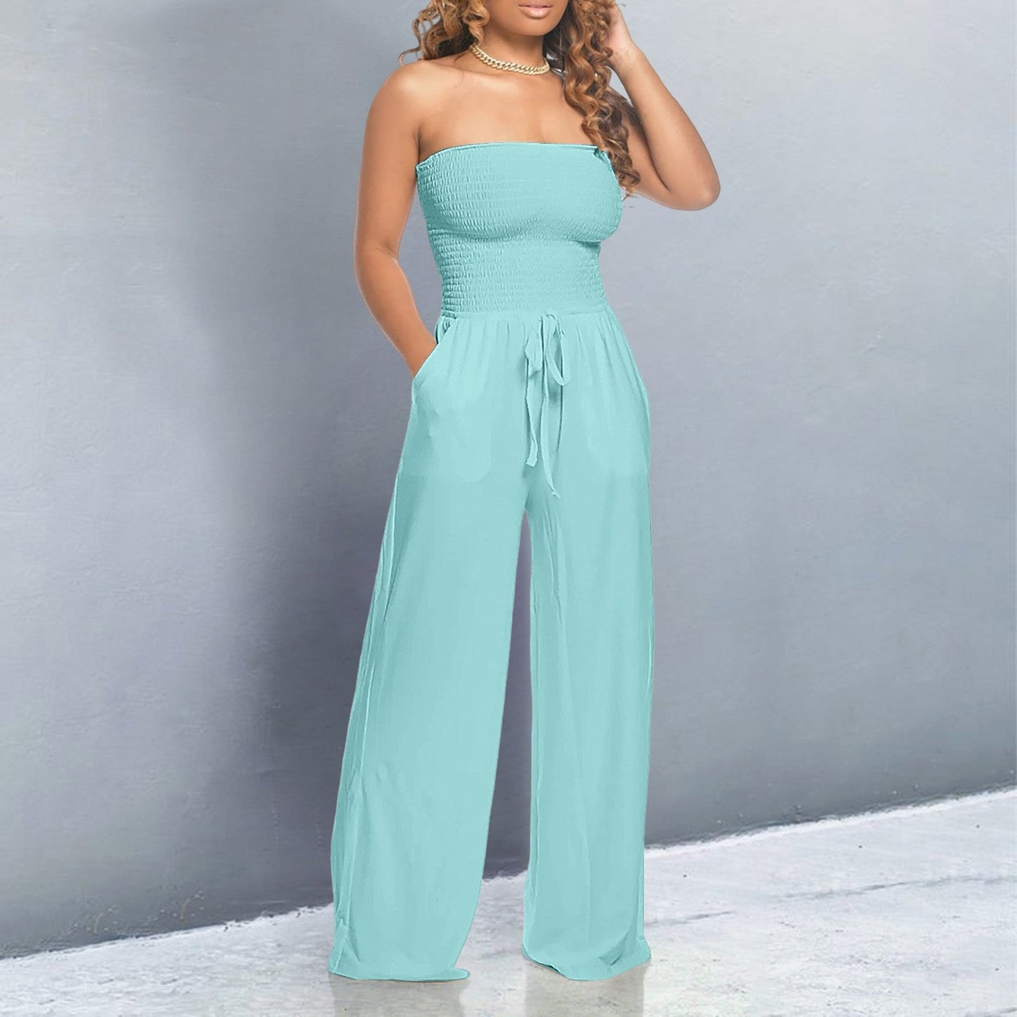 Women's black off-shoulder wide-leg jumpsuit with strapless form-fitting bodice and flowing silhouette