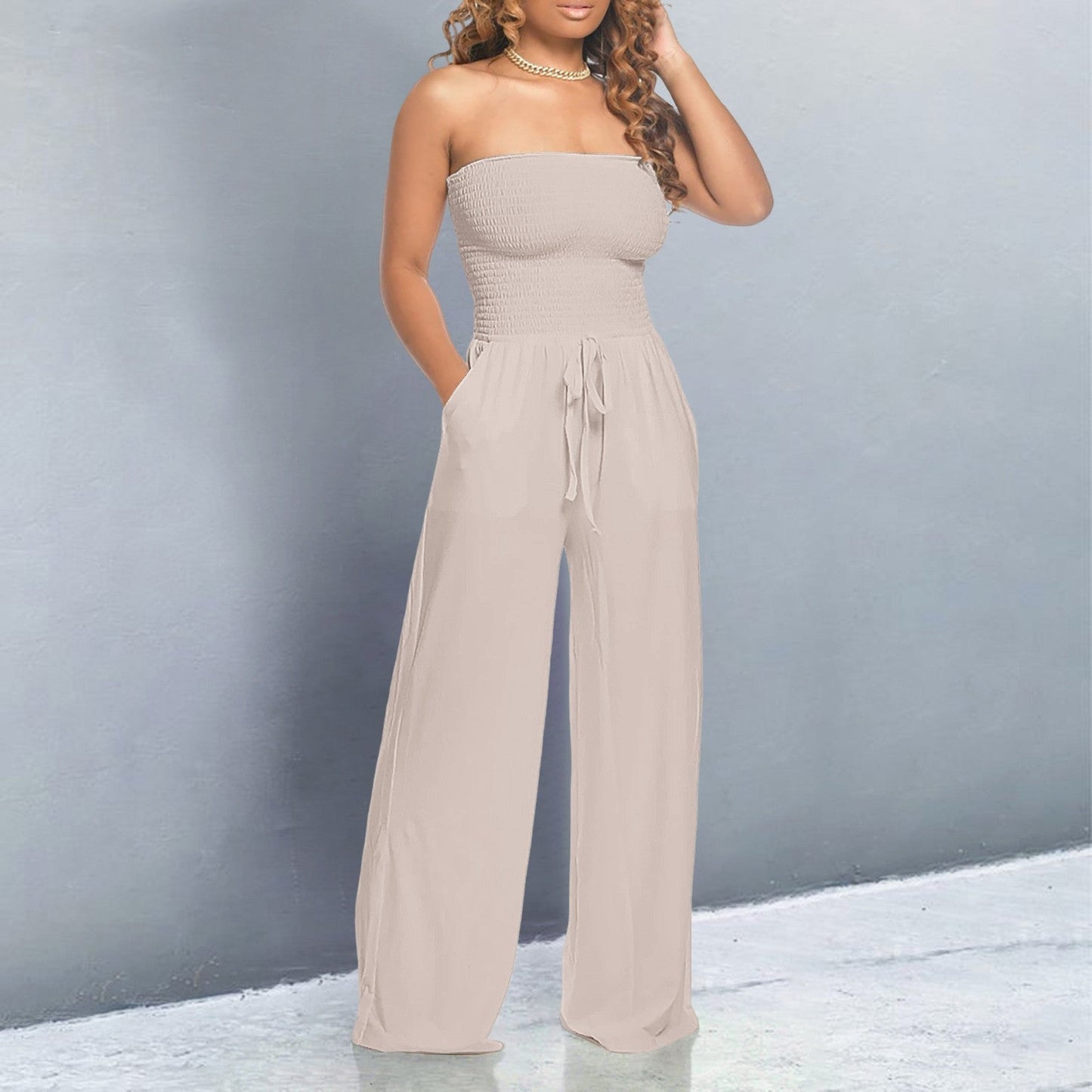Women's black off-shoulder wide-leg jumpsuit with strapless form-fitting top and flowing silhouette