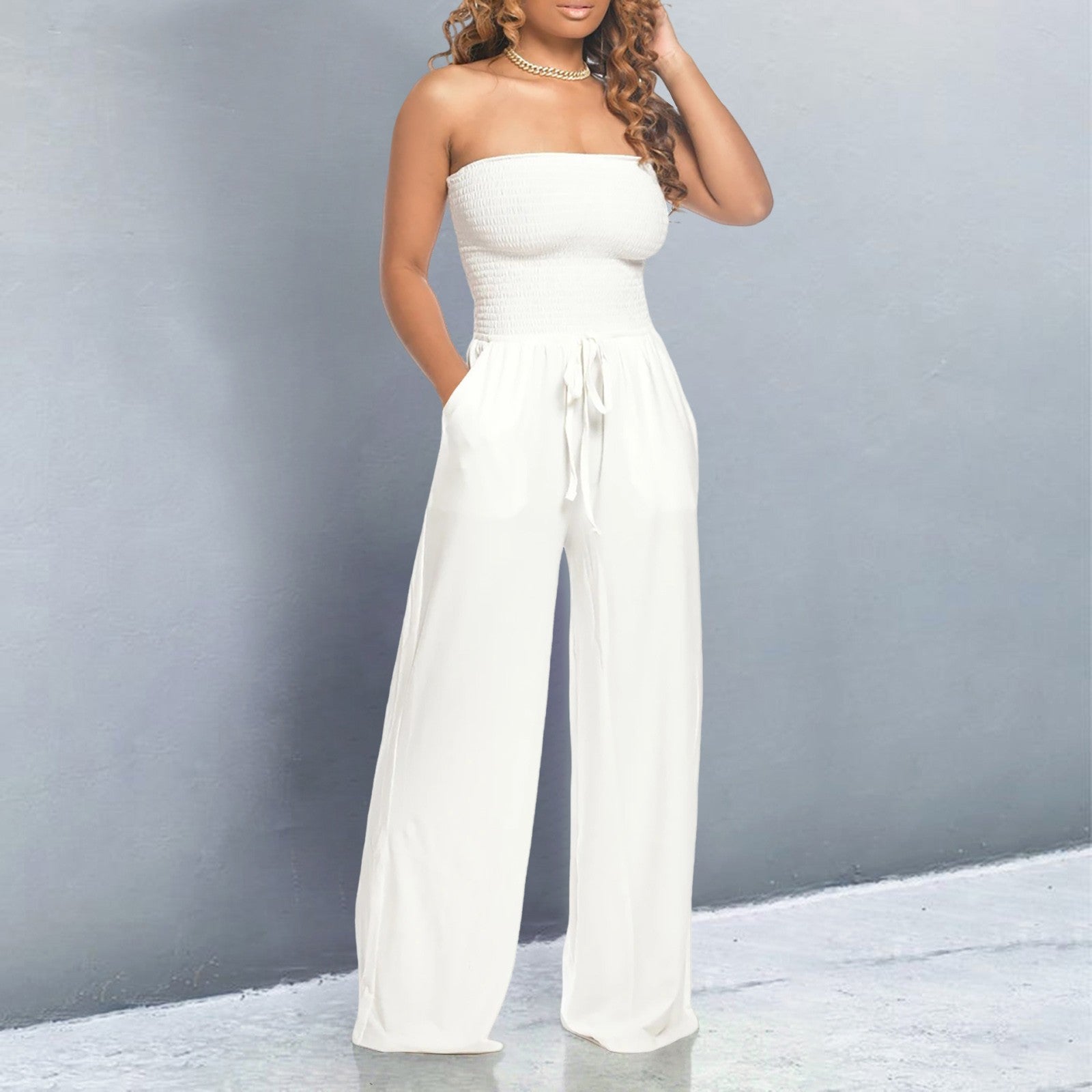 Women's black off-shoulder wide-leg jumpsuit with strapless form-fitting bodice and flowing silhouette
