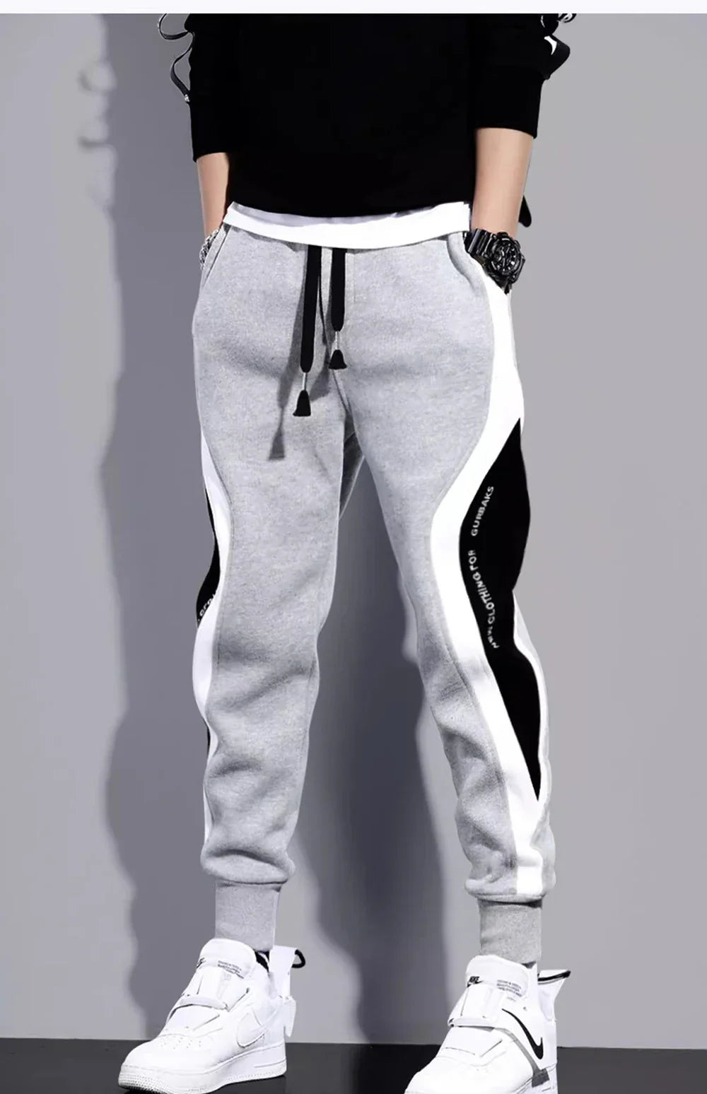 Men's loose fit sports pants with colorblock patchwork side panels, relaxed silhouette for spring
