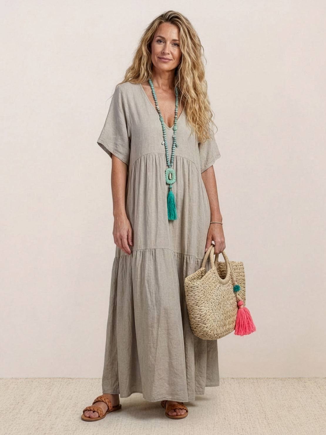 Terracotta tiered maxi swing dress with deep V-neckline, short sleeves, and flowing two-tier bohemian silhouette