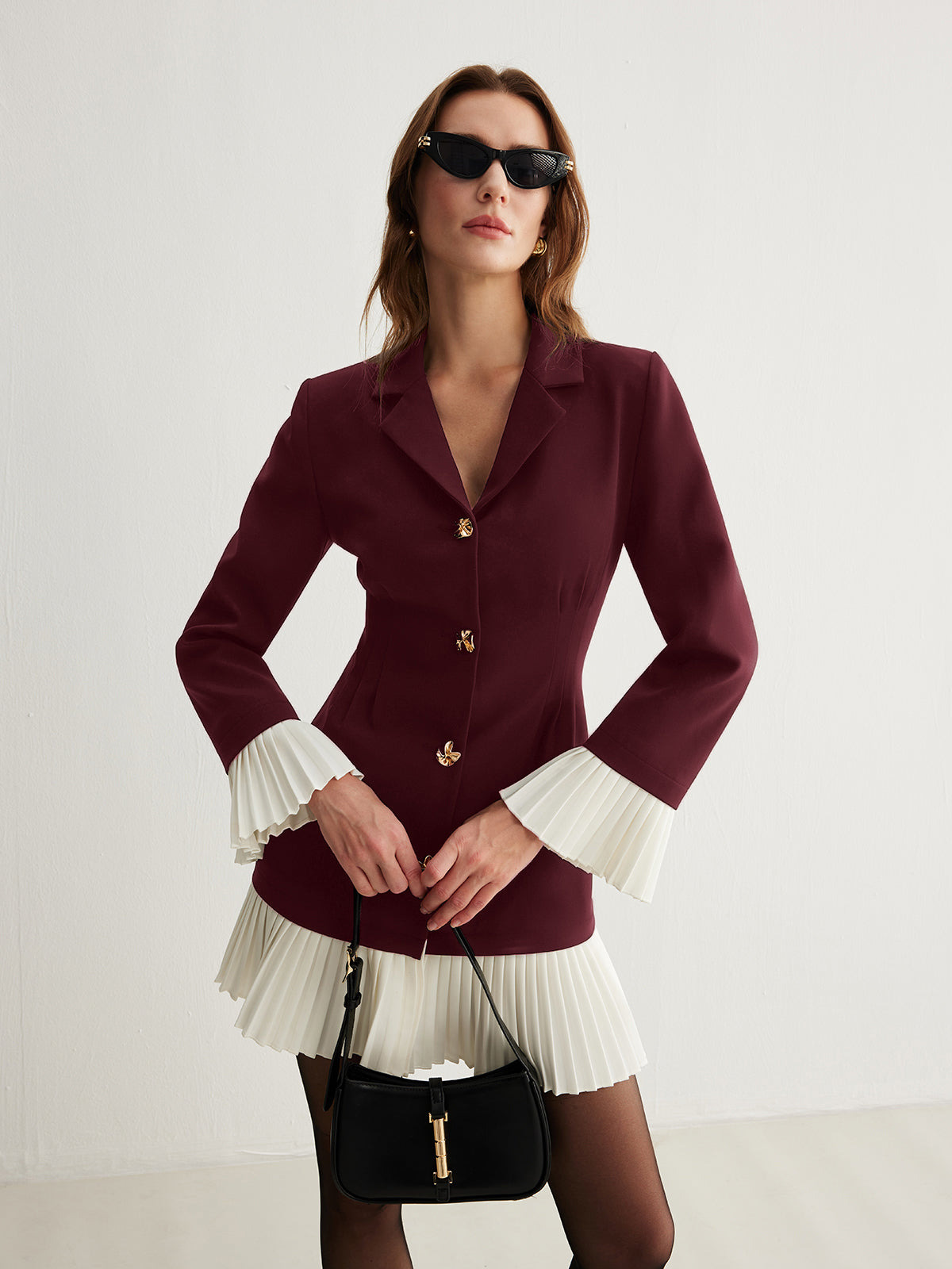White and navy two-tone pleated button dress with V-neck, pleated cuffs and hem detail