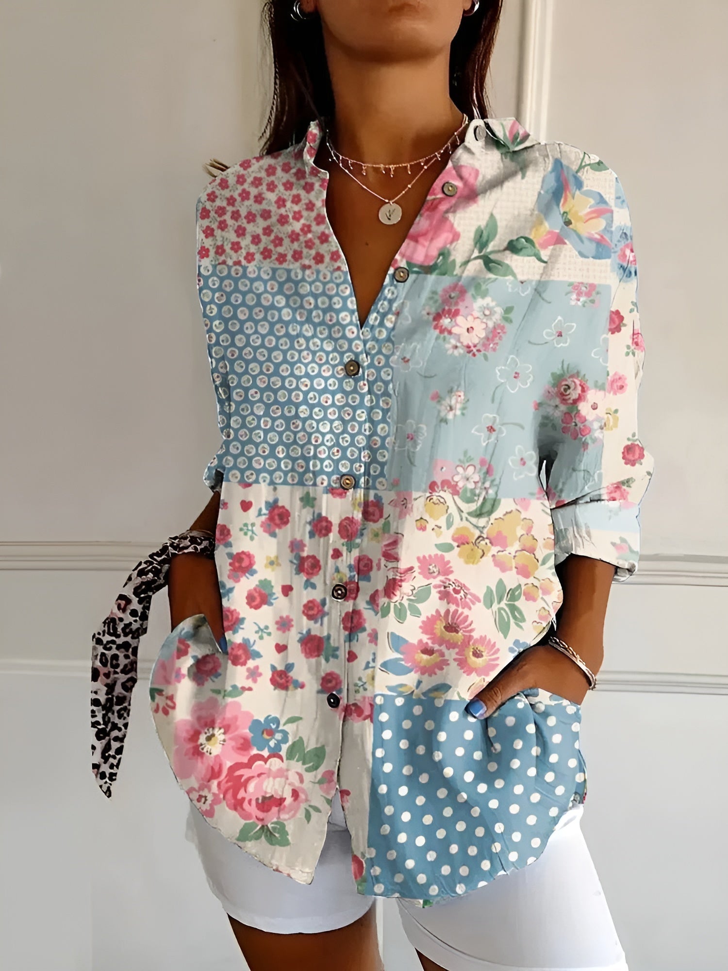 Chic women's blouse with whimsical floral prints, lightweight airy fit, and playful sophisticated style
