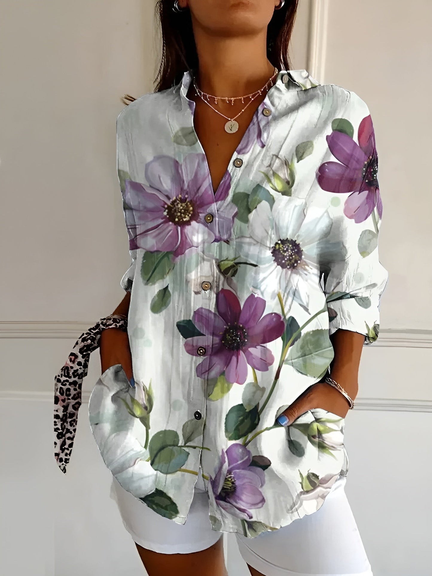 Chic women's blouse with whimsical floral prints, lightweight airy fit, and flattering silhouette