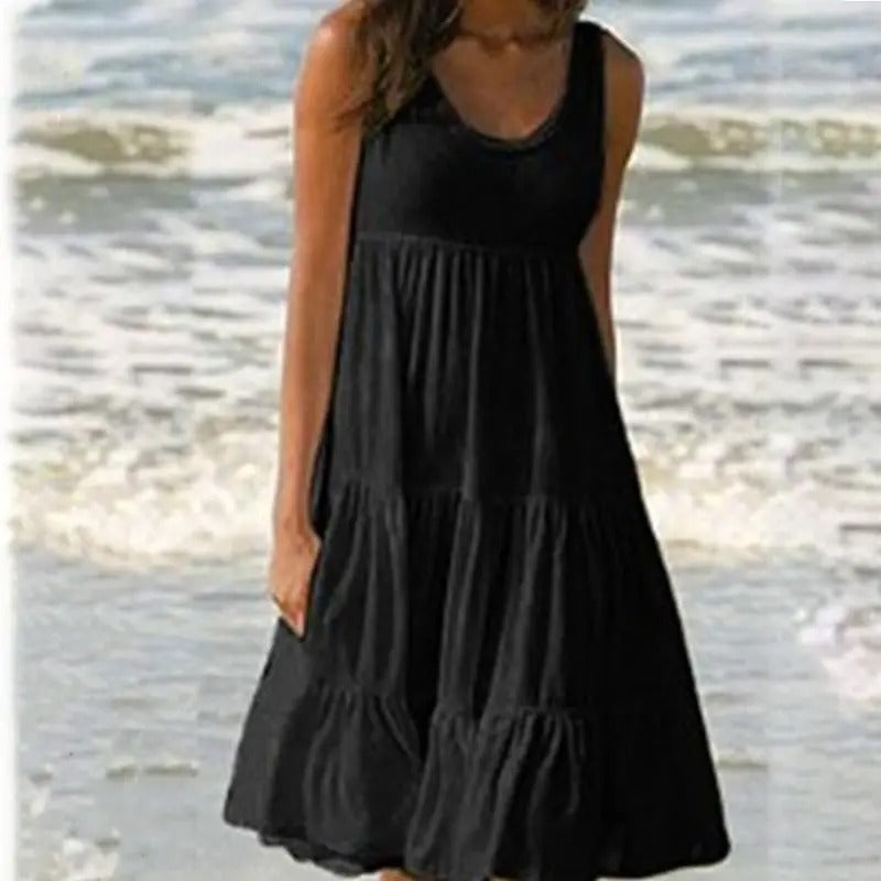 Black sleeveless bodycon dress with open back detail and subtle hem split, sleek evening style