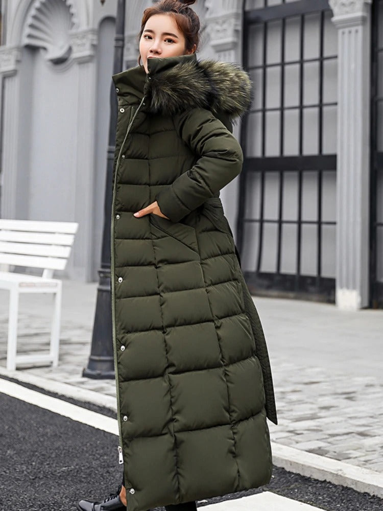 Women's long black belted puffer coat with fur trim hood, quilted longline silhouette