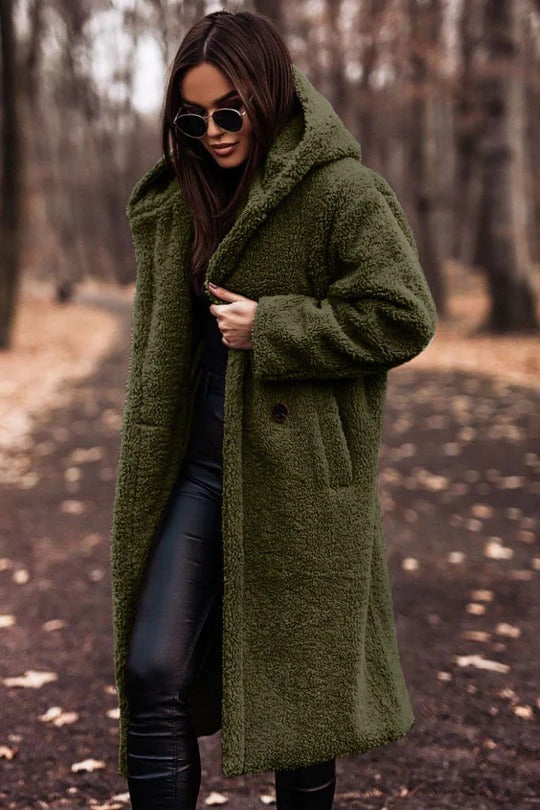 Structured mid-length winter coat with high collar, button closure, waist belt, and insulating thick fabric