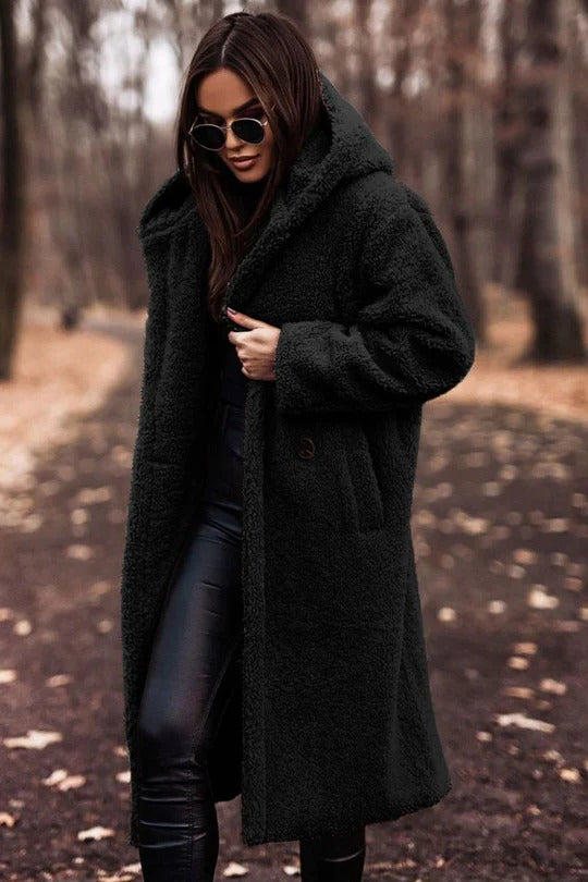 Structured mid-length winter coat with high collar, button closure, waist belt, and insulating thick fabric