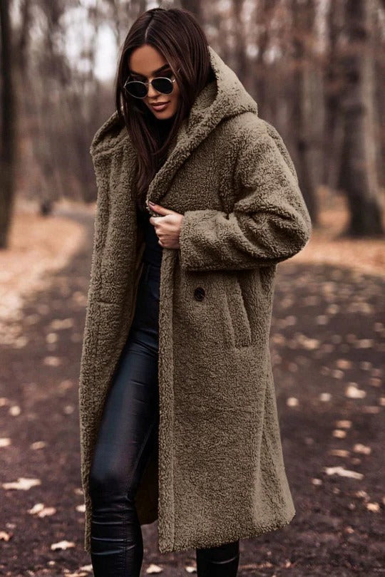 Structured mid-length winter coat with high collar, button closure, waist belt, and insulating thick fabric