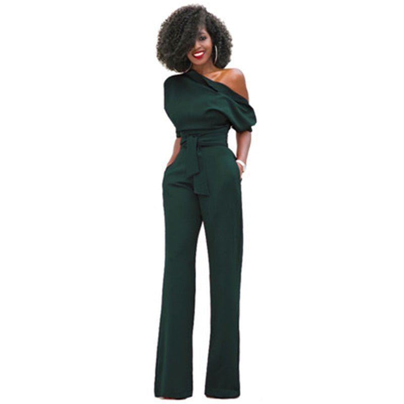 Red wide-leg formal jumpsuit with off-shoulder asymmetric neckline, puff sleeve, and cinched waist belt