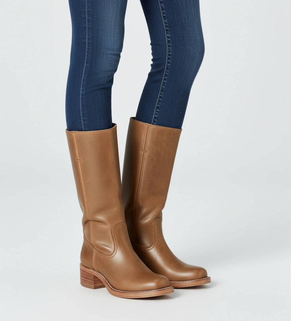 Women's black faux leather knee-high boots with block heel and Western-inspired pull-on silhouette