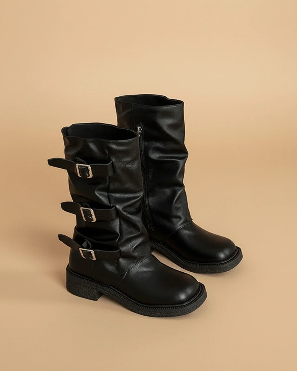 Women's mid-calf slouchy black boots with bold platform lug sole and statement buckle accents