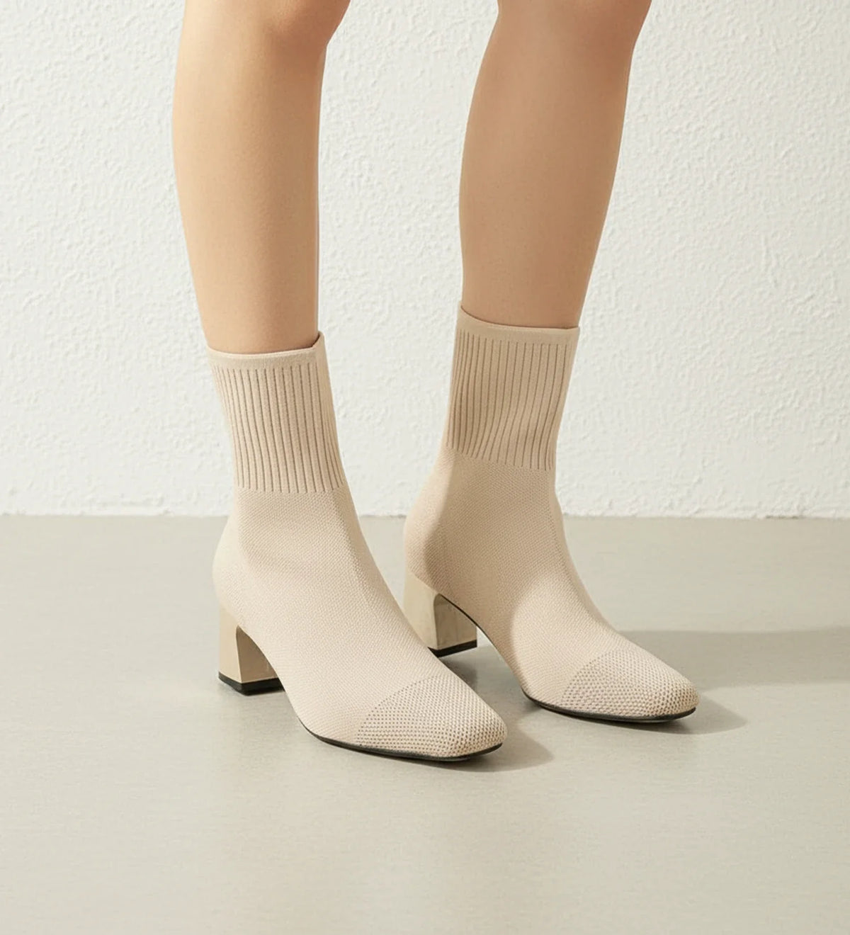 Women's black sock-knit ankle boots with block heel, sleek form-fitting silhouette for everyday elegance