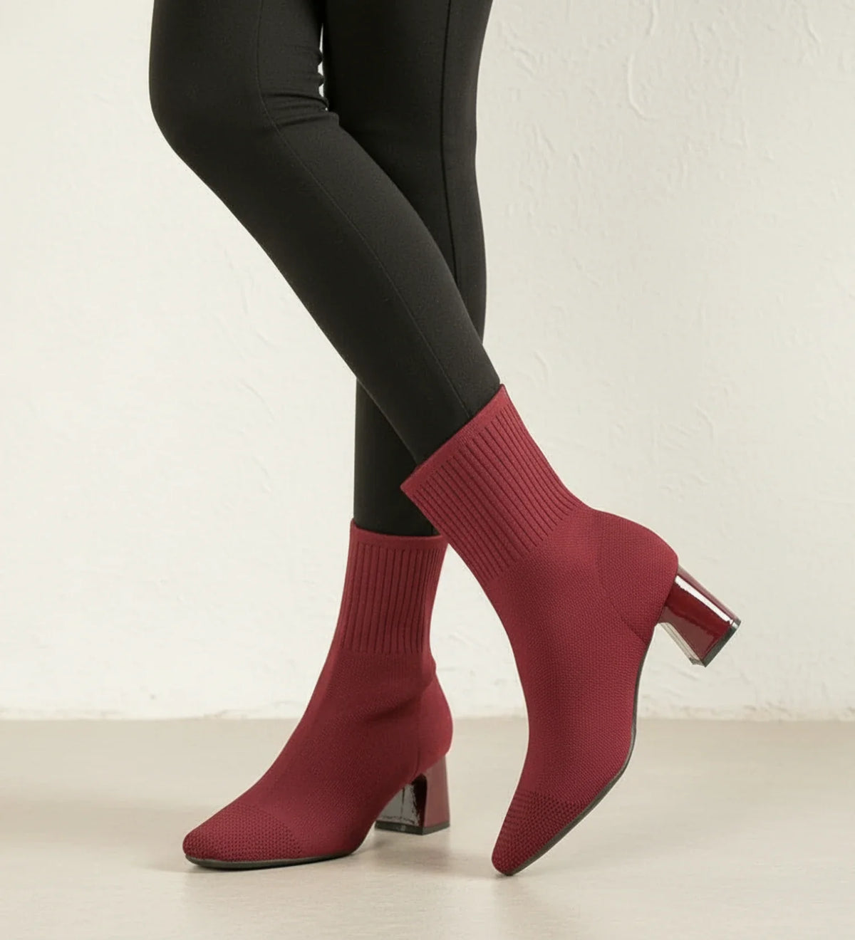 Women's black sock-knit ankle boots with block heel, sleek form-fitting silhouette for everyday elegance
